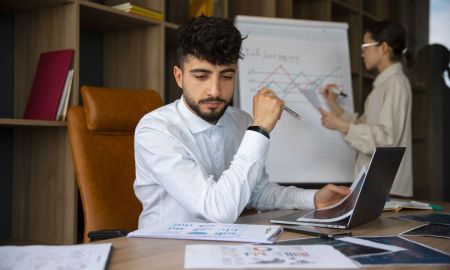 office workers using finance graphs