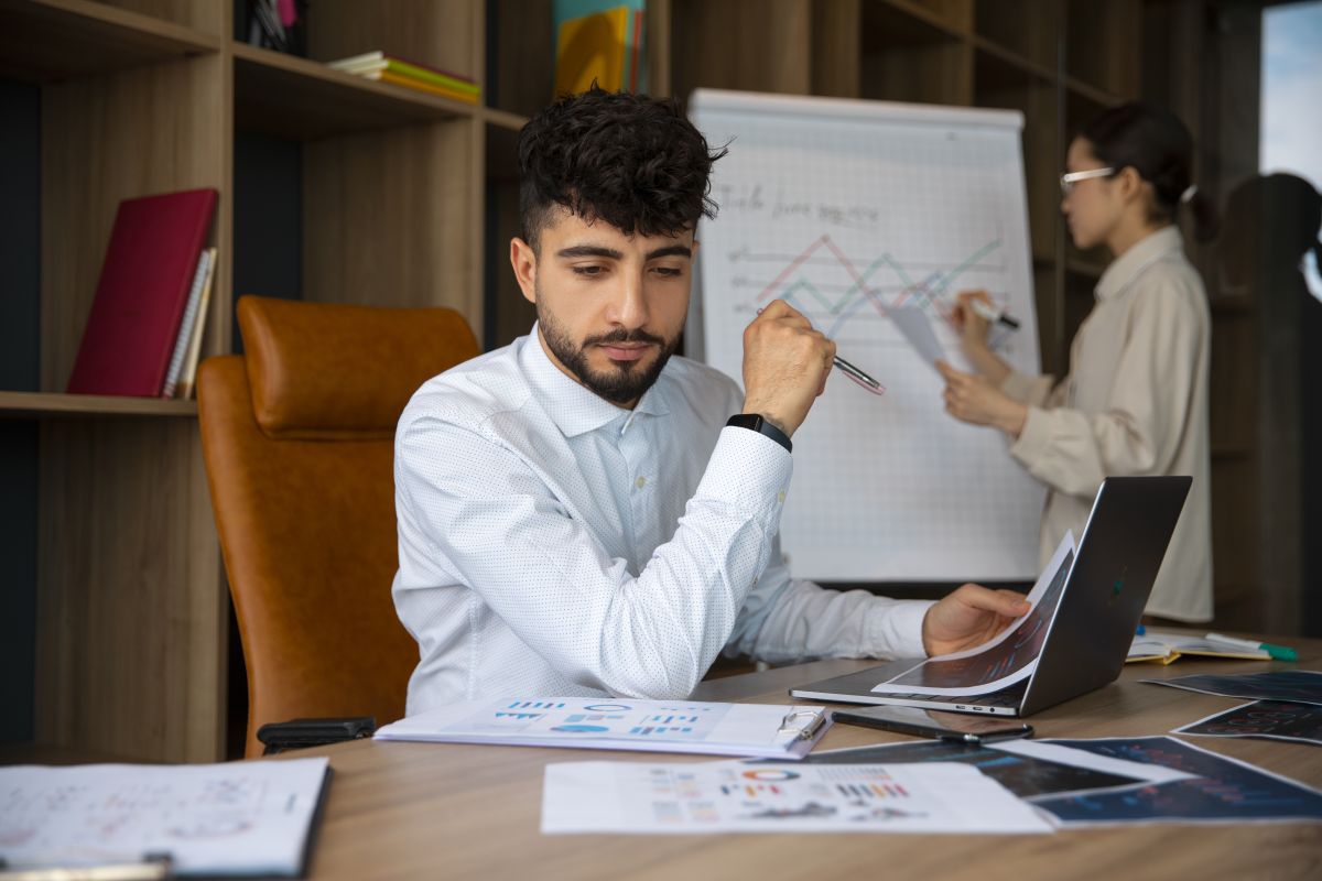 office workers using finance graphs