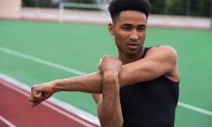 handsome african athlete man make stretching exercises