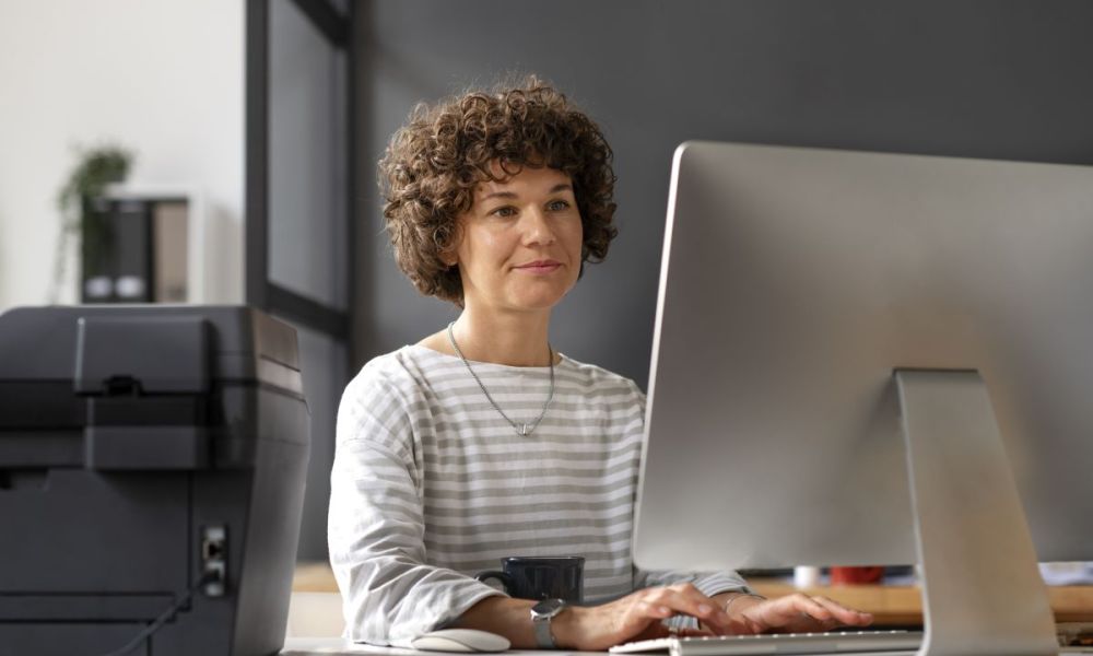 side view woman working computer