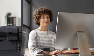 side view woman working computer