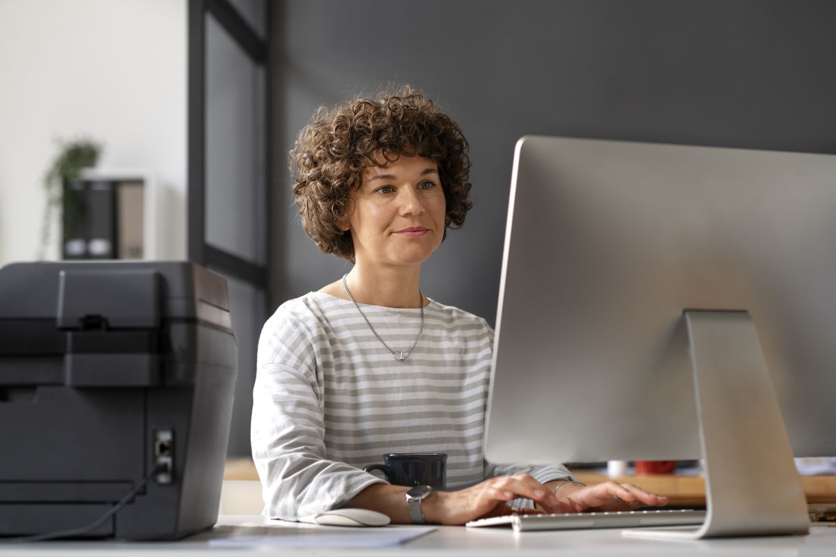 side view woman working computer